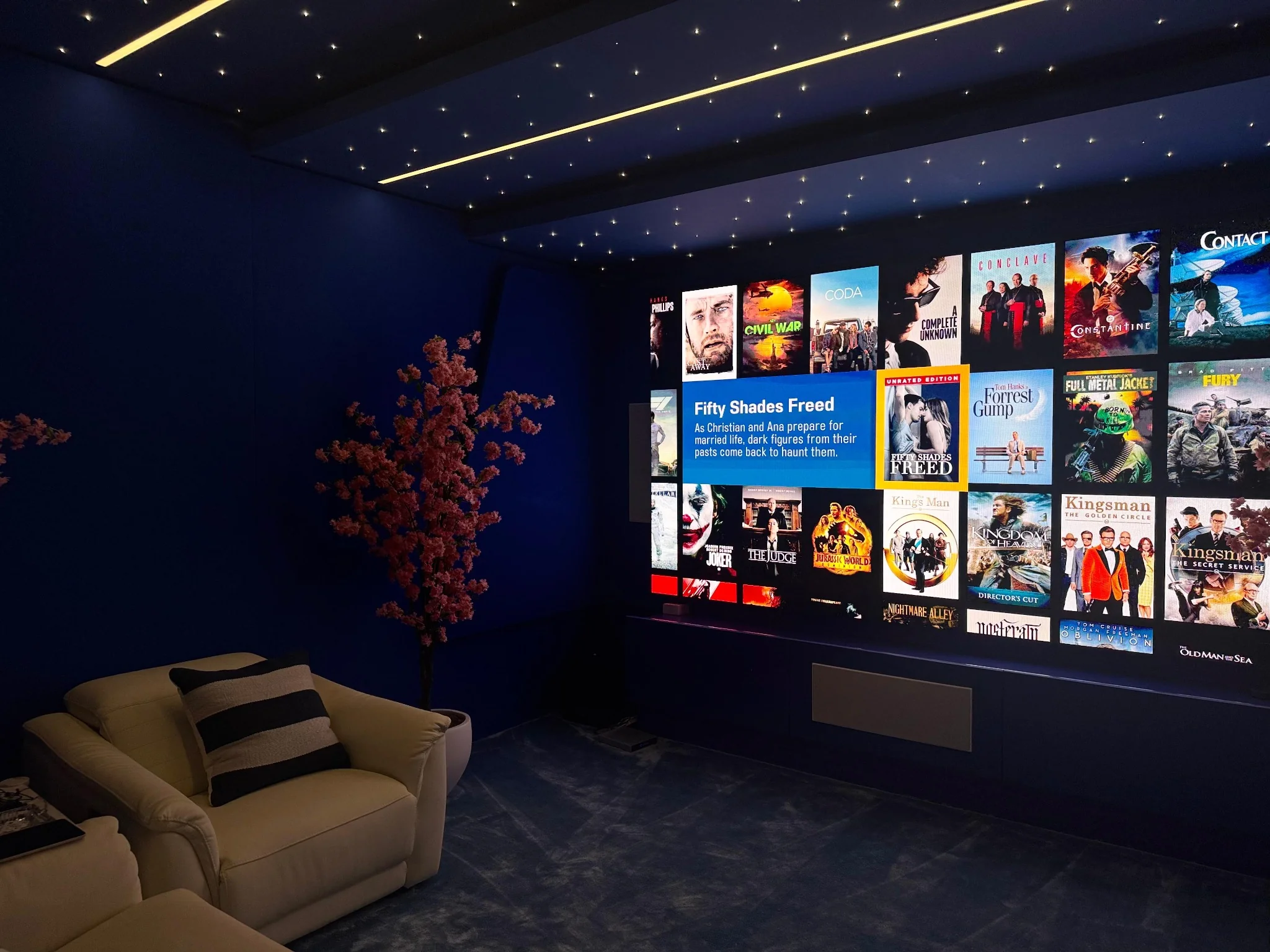 LED video wall cinema room with star ceiling, Bowers & Wilkins speakers, and Savant automation by LuxSmart.