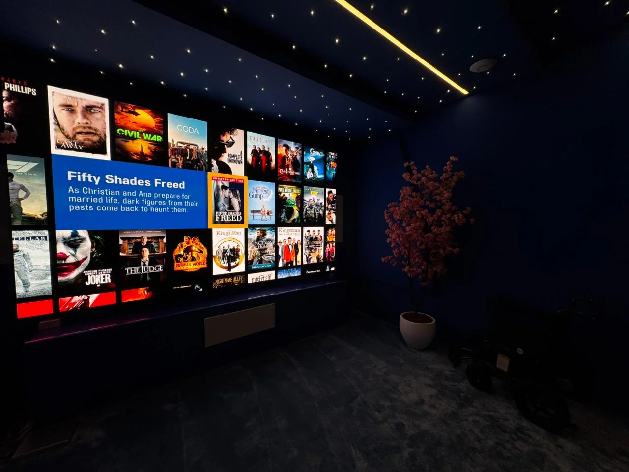 Luxury private home theatre featuring KNX lighting and Savant AV control with Kaleidescape movie server.